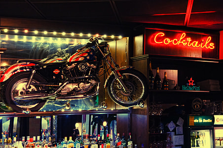 black and red cruiser motorcycle near glass bottle lot thumbnail