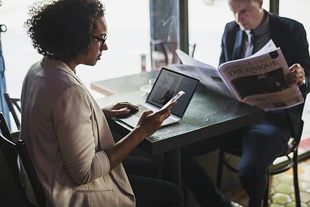 Man and Woman Sitting in Front of Black Table thumbnail