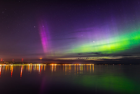 body of water under aurora sky phenomenon thumbnail