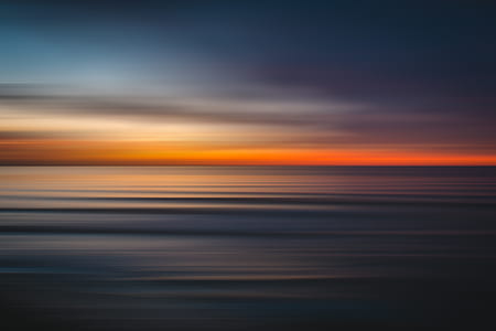 panoramic photography of body of water at sunset thumbnail
