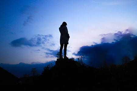 silhouette of person standing on the cliff thumbnail