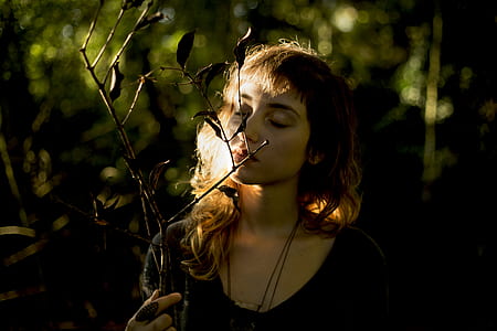 woman sniffing branch thumbnail