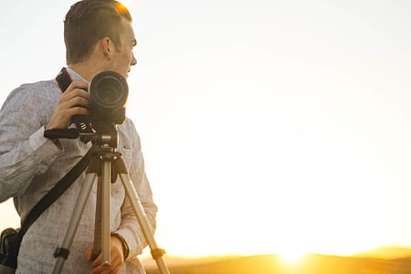man standing with camera thumbnail