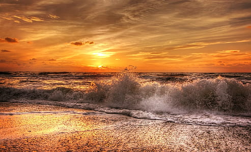 sea waves crashing on shore during sunset thumbnail