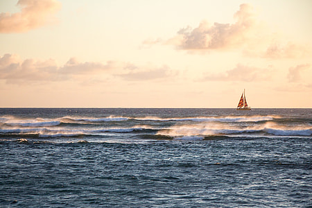 red sail boat on body of water during daytime thumbnail