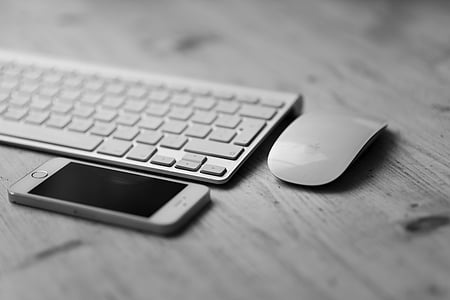 grayscale photography of iPhone 5s beside keyboard and mouse thumbnail
