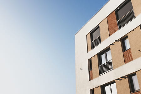 white and brown painted building under sky thumbnail