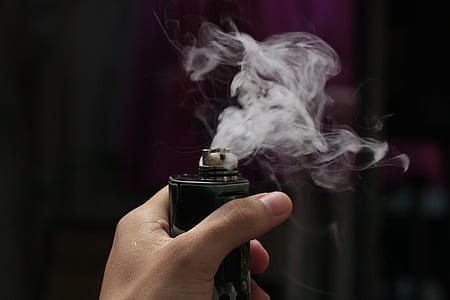 person holding black box mod vape emitting smoke thumbnail