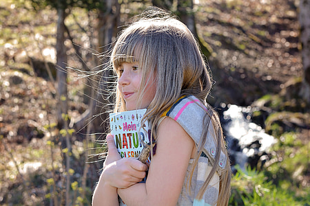 girl hugging book thumbnail
