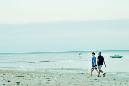 man walking beside seashore thumbnail