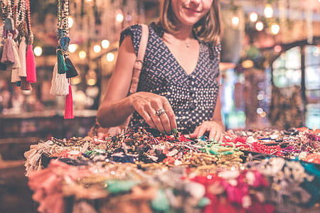 depth of field photography of woman holding beaded necklace thumbnail