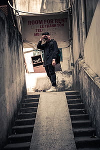 Man Wearing Black Long-sleeved Shirt Holding Black Camera thumbnail