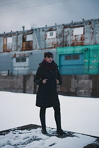 women's black and red coat on snow thumbnail