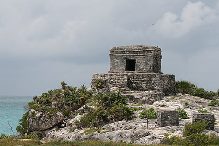 gray concrete ruins near body of water thumbnail