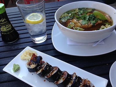 sushi on plate beside drinking glass thumbnail