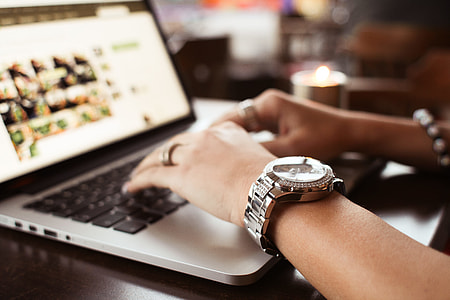 Girl with Watches Typing on MacBook thumbnail