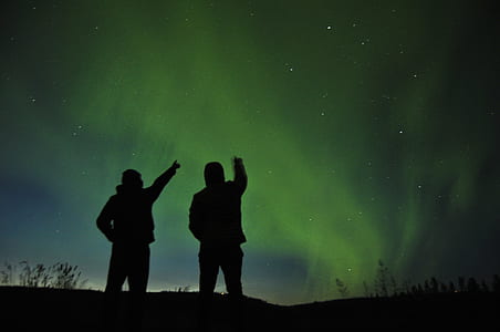 silhoutte of two person under aurora borealis thumbnail