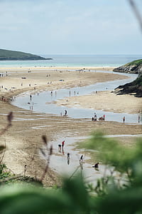 people at beach with artificial river thumbnail