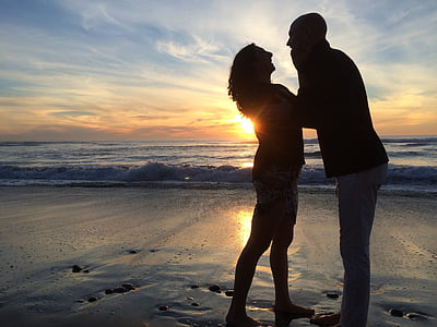 silhouette of couple on seashore thumbnail