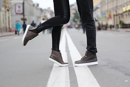 woman and man both wearing brown high top shoes thumbnail