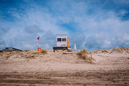white wooden shed near open field at daytime thumbnail