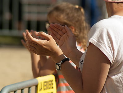 woman standing beside girl near gray fence during daytime thumbnail