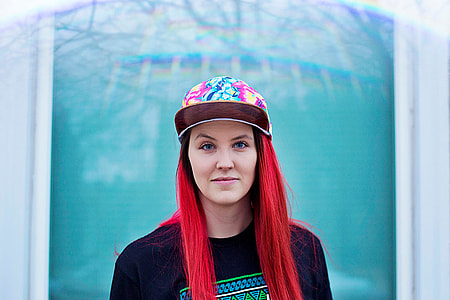 red haired woman in black crew neck shirt and multi color snapback thumbnail