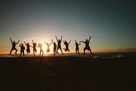 Silhouette Photography of Group of People Jumping during Golden Time thumbnail