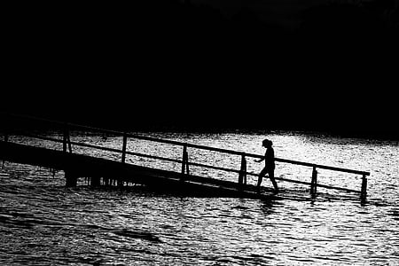 person walking up wooden ramp from water thumbnail