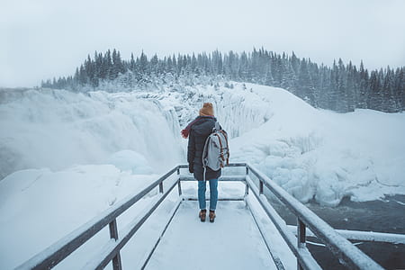 woman standing on balcony covered with snow thumbnail
