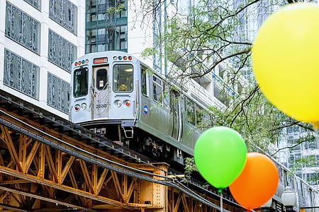 gray train near white buildings during daytime thumbnail