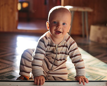 baby crawling on floo thumbnail