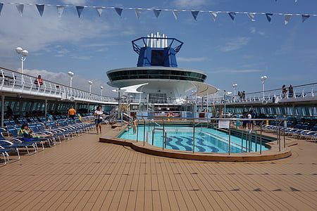 woman walking near ship swimming pool during day thumbnail