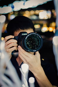 selective photography of man taking photo thumbnail