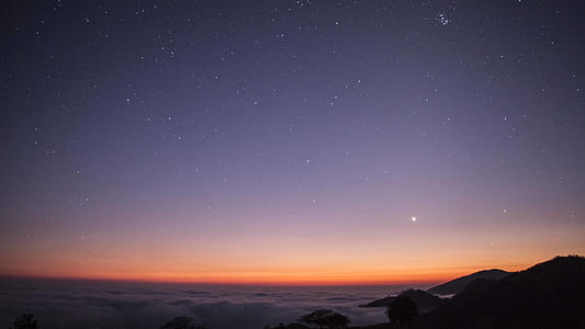 silhouette of mountains during nighttime thumbnail