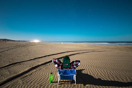person sitting on chair on desert during daytime thumbnail