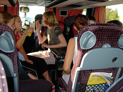 group of girls sitting inside bus while talking thumbnail
