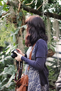 Woman in Blue Cardigan Holding Canon Dslr Camera thumbnail