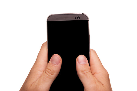 person holding gray HTC One Android smartphone thumbnail