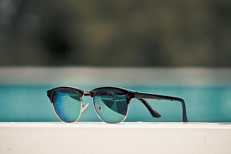 blue clubmaster sunglasses on white surface thumbnail