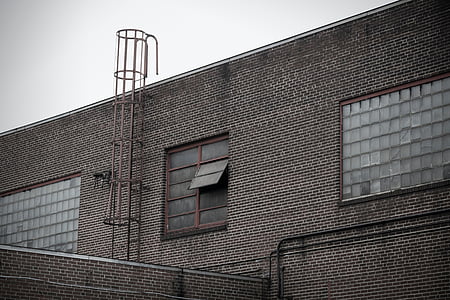 gray metal tunnel ladder on building during daytime thumbnail