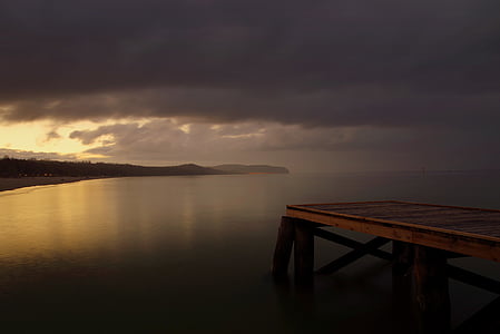 brown wooden dock in front of body of water thumbnail