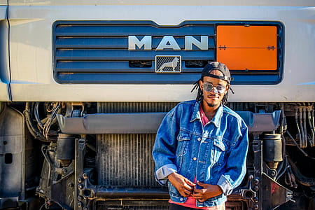 Man Standing in Front of Truck thumbnail