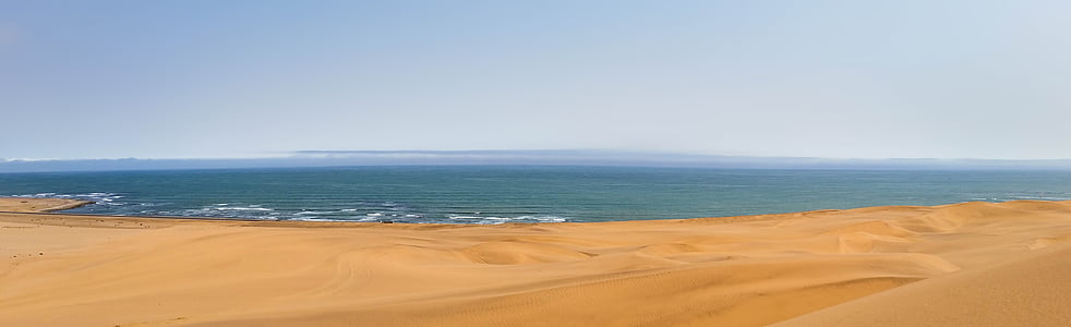 brown sand and body of water photography thumbnail