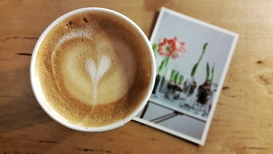 Espresso on White Ceramic Cup on Red Flower Photograph thumbnail