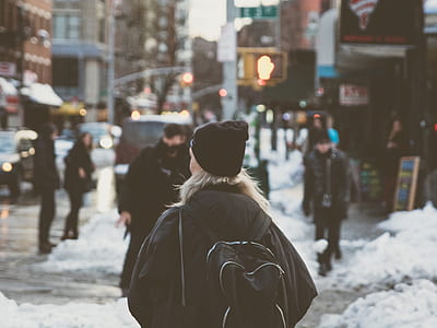 selective focus photography of woman walking on the road thumbnail