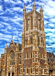 beige concrete cathedral under cloudy sky during daytime thumbnail