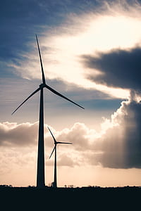 Silhouette Photo of Two Wind Mills during Golden Hour thumbnail