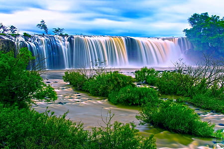 HD photography of waterfalls surrounded by green grasses and trees during daytime thumbnail