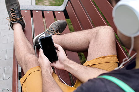 Young guy on the bench enjoying the music thumbnail